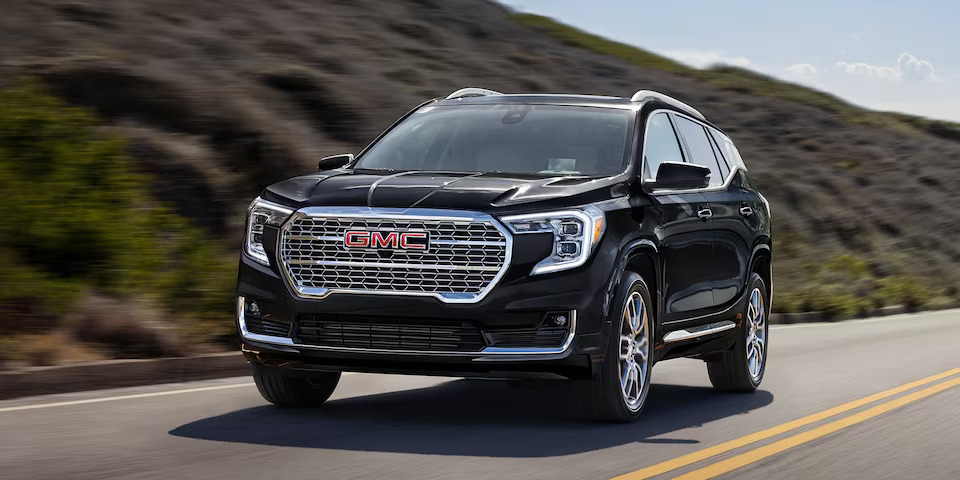 A certified pre-owned GMC SUV on the road