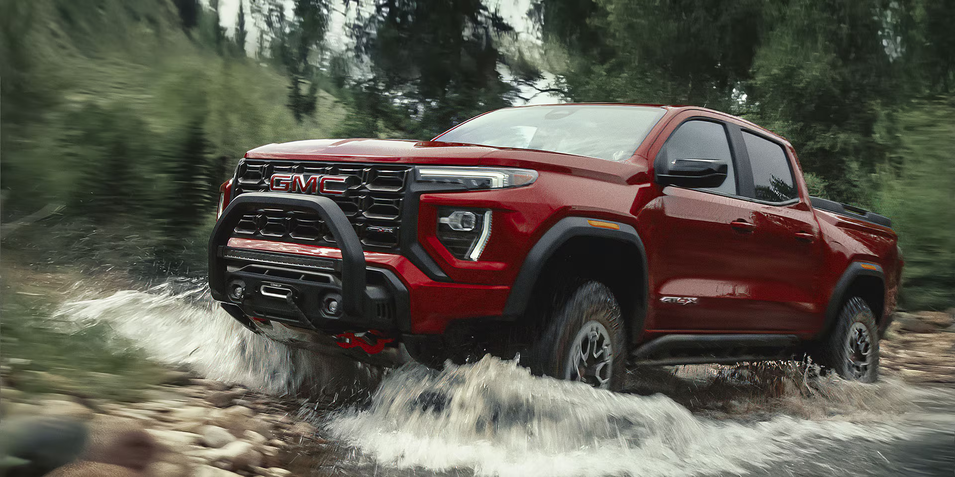 The 2026 GMC Canyon going through a river