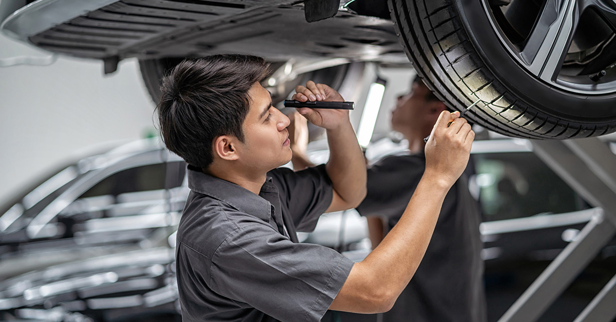 Buick service technician inspecting tires