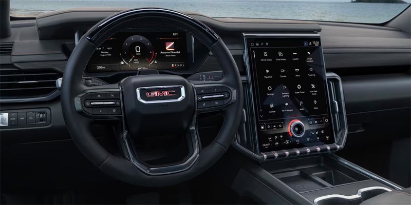 Interior View of the GMC Acadia Steering Wheel, Infotainment System, and Dashboard