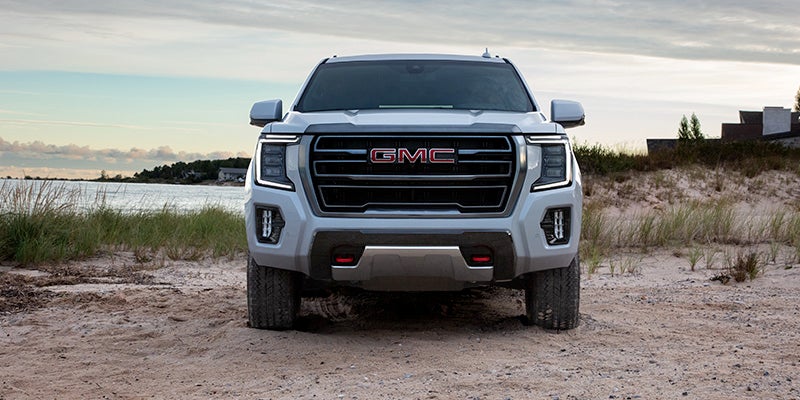 2024 GMC Yukon parked on a sandy beach