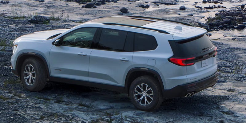 GMC Acadia parked in a picturesque outdoor landscape.