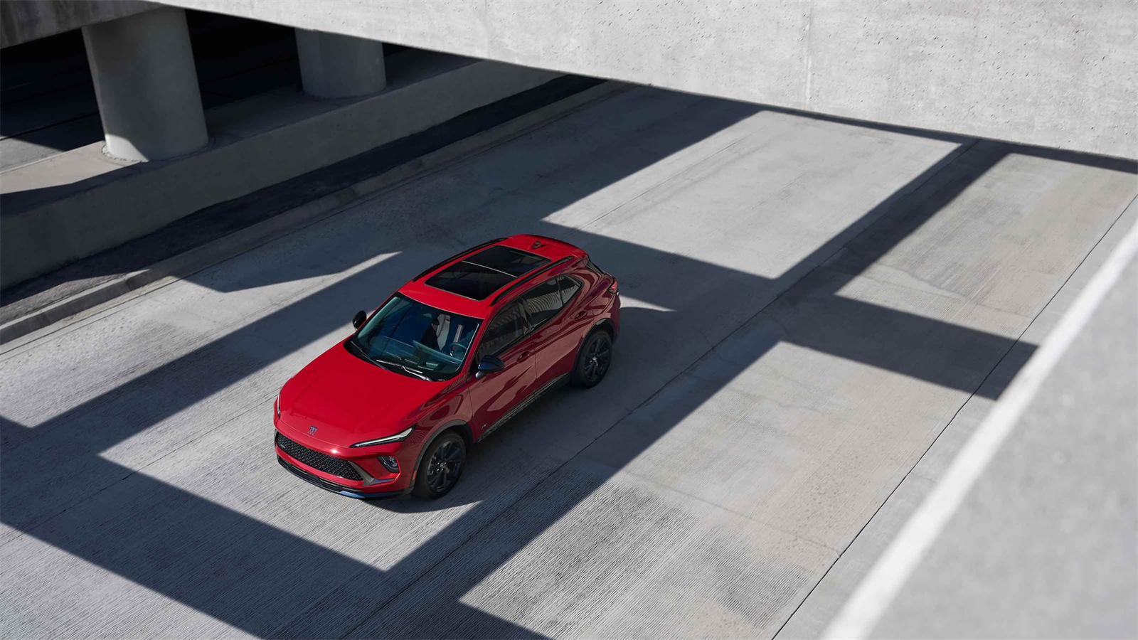 Red 2026 Buick Envision overhead view on expressway.