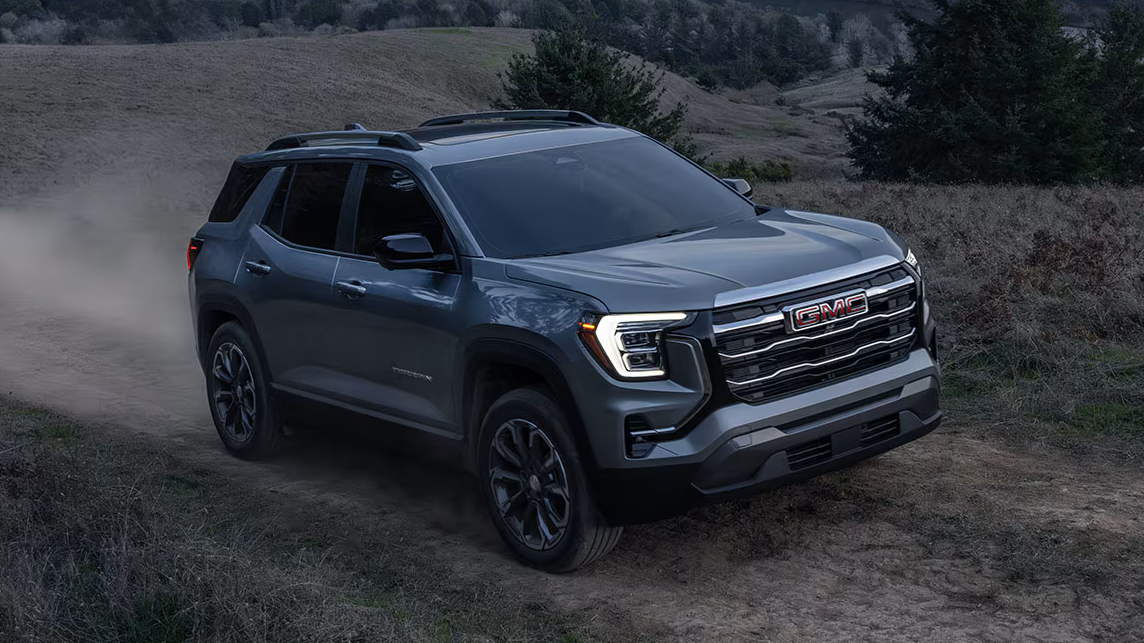 Gray 2027 GMC Terrain driving on dirt trail