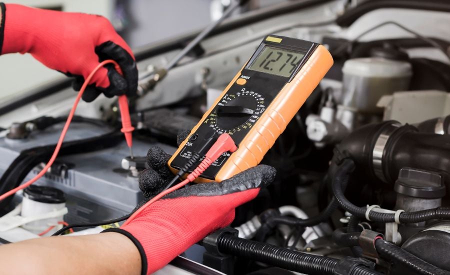 GMC service technician checking a battery