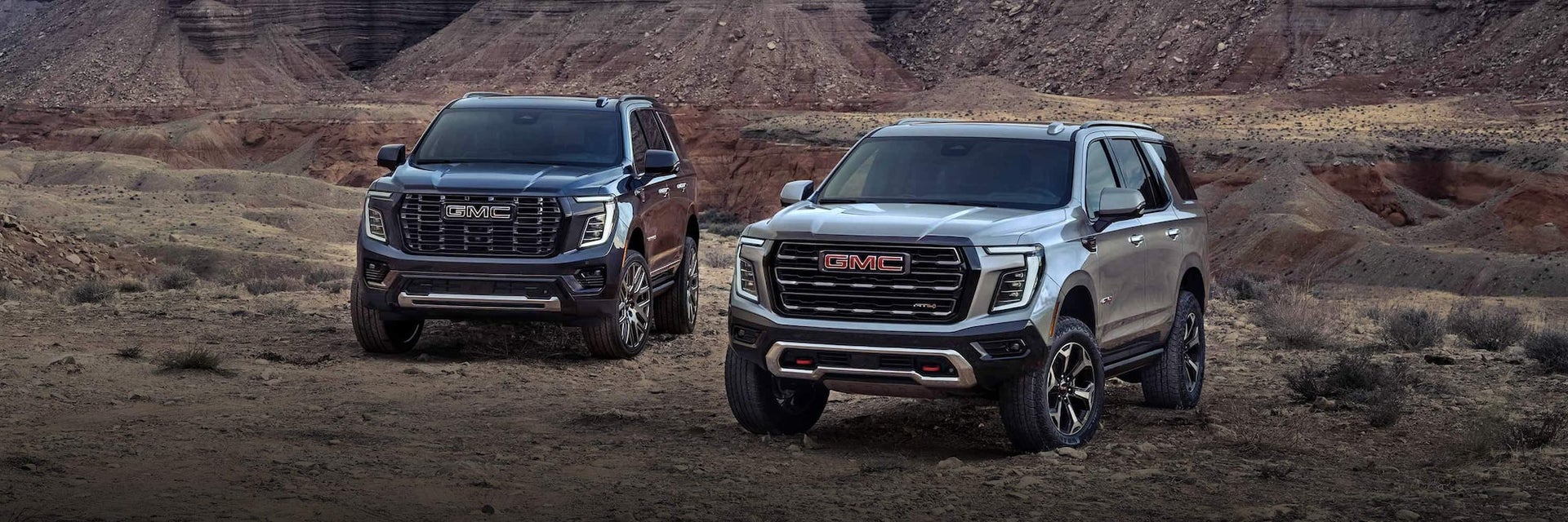 The 2025 GMC Yukon and Yukon XL SUVs Parked in the Desert